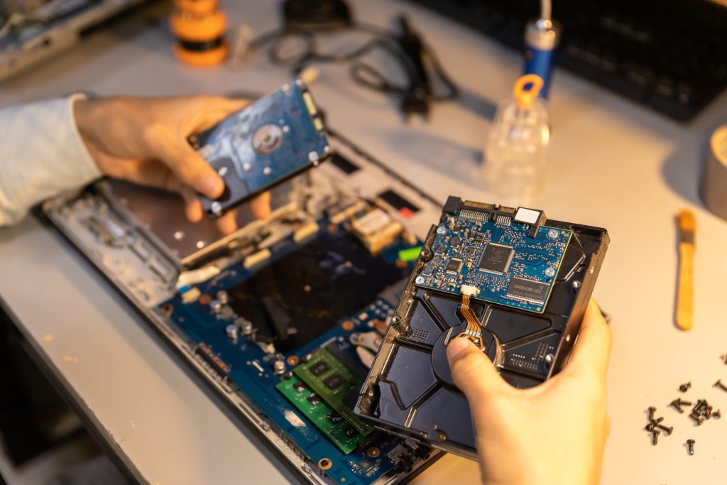 Computer repair technician repairing a laptop